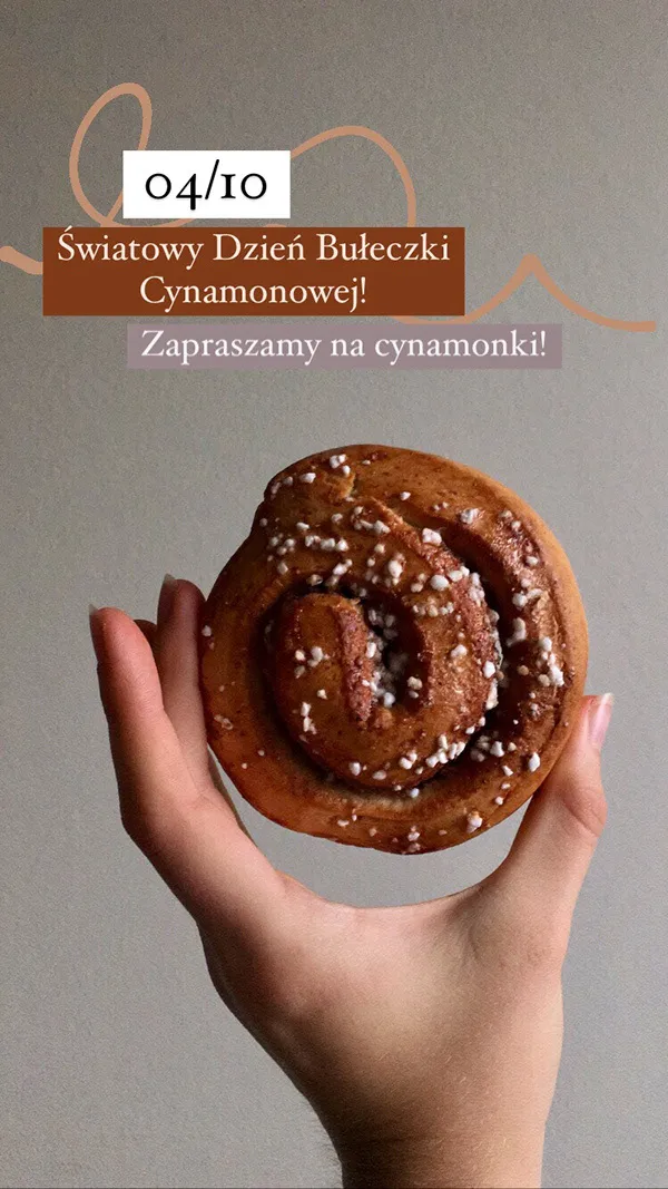 An Instagram story showing a hand holding a cinnamon bun.