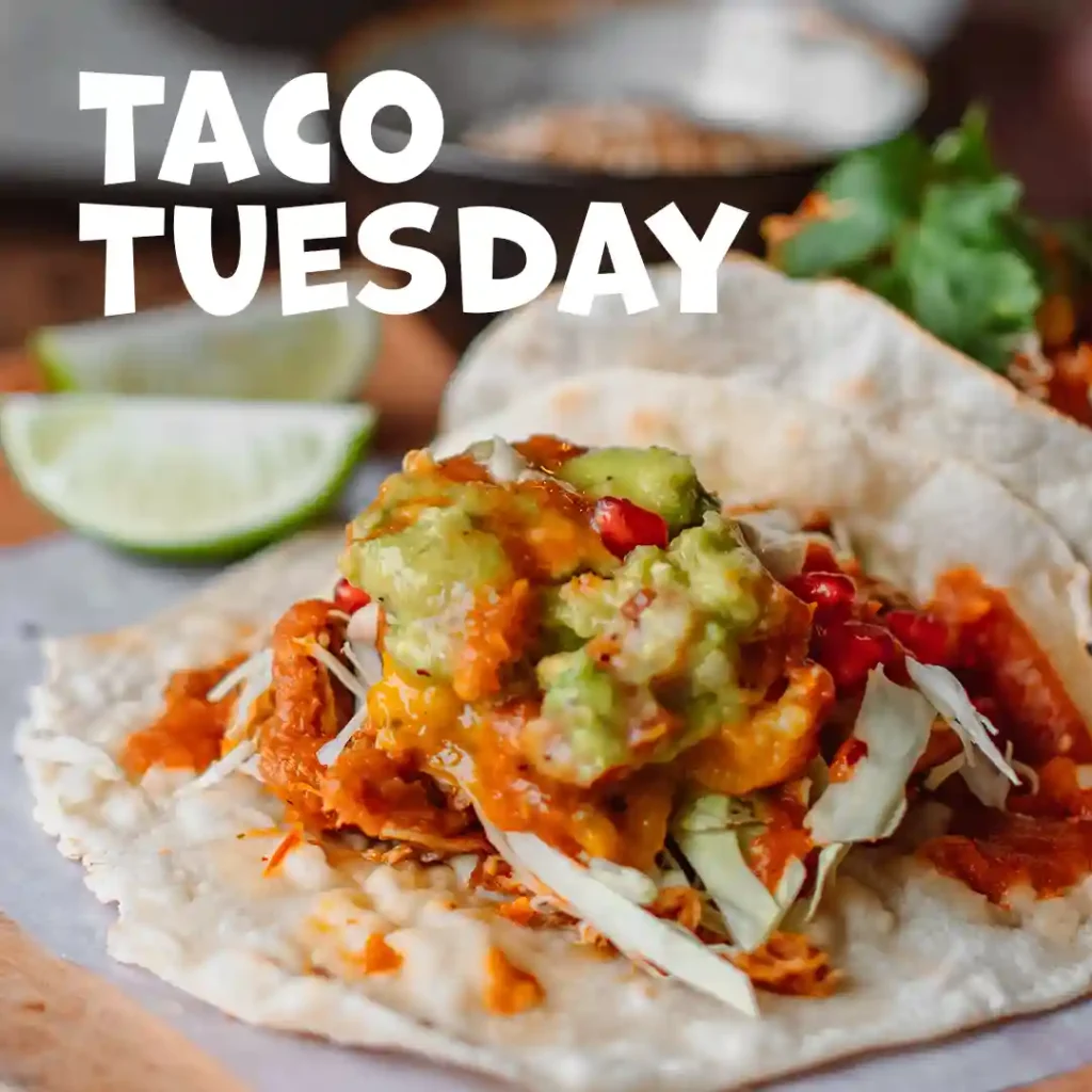 The Instagram post displaying a seasonal offer of Holy Guacamole, Taco Tuesday. In the background, there are bowls with ingredients. In the front, one taco with a splash of salsa and guacamole.