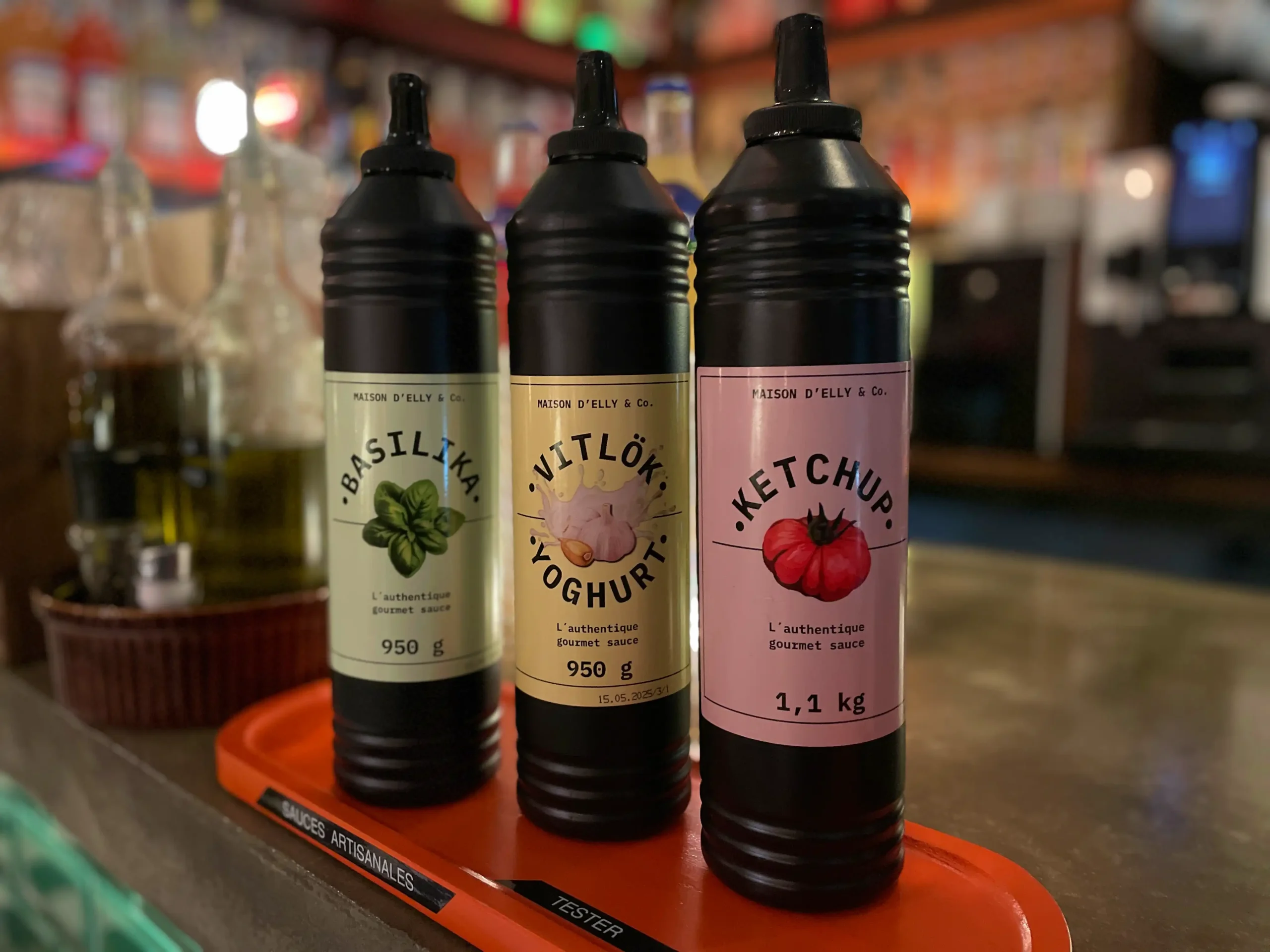 Three bottles of SMBT sauces. From left: basilica, yoghurt aioli, and ketchup.